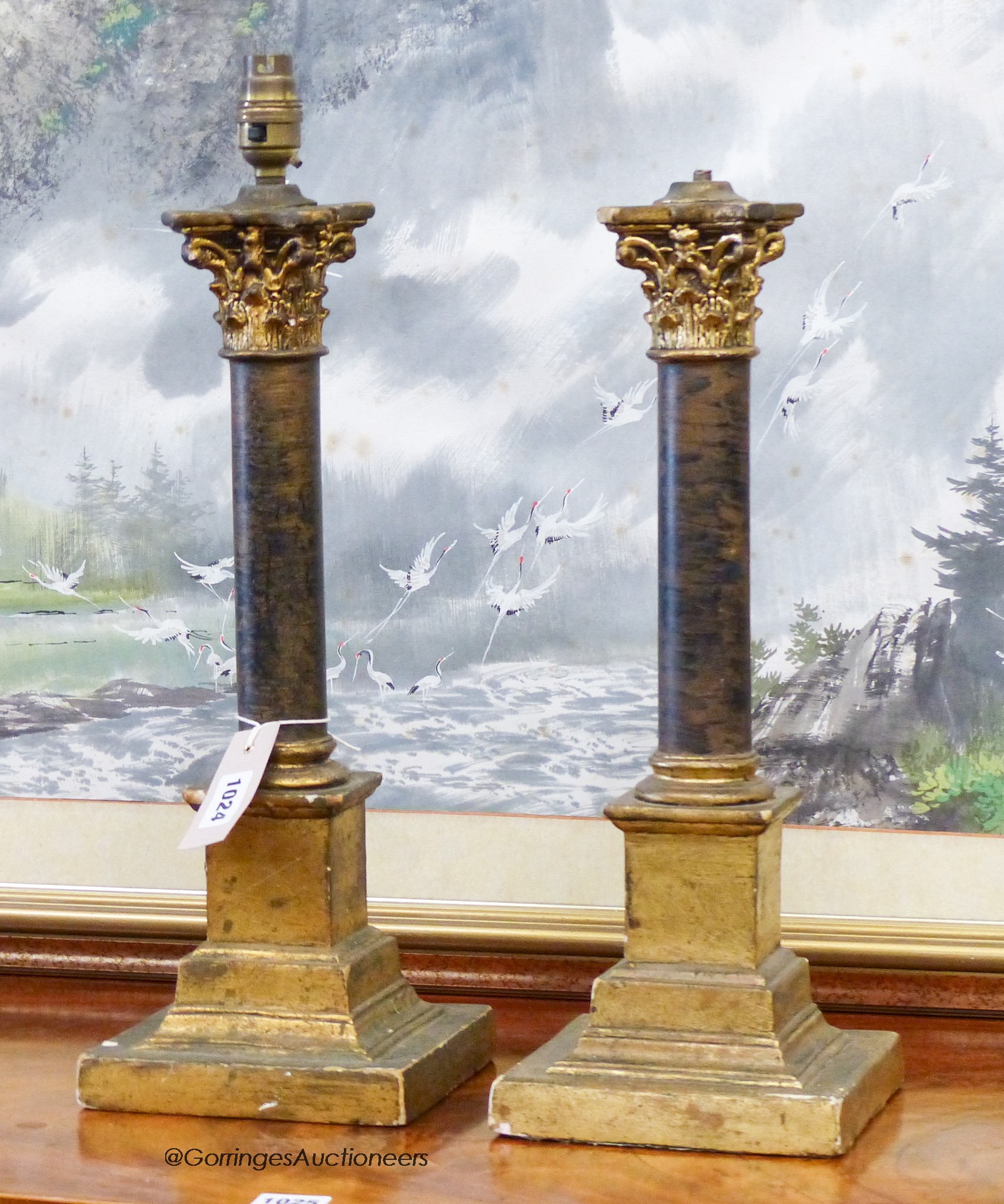 A pair of faux ormolu corinthian column table lamps, height 43cm